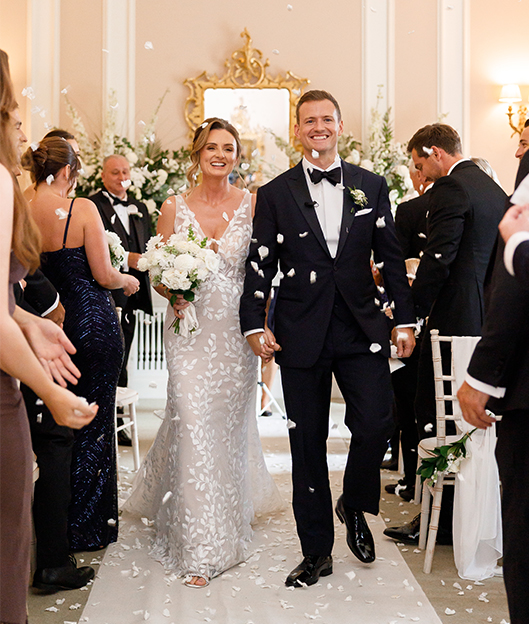 Bride and groom walk down aisle